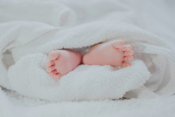 タオルに包まれた赤ちゃんの足